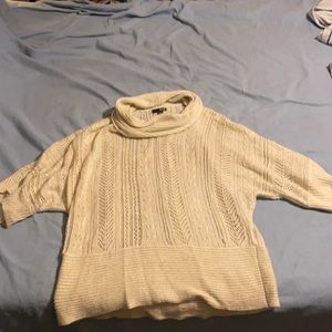 Cream colored short sleeve sparkle Cowell neck shirt